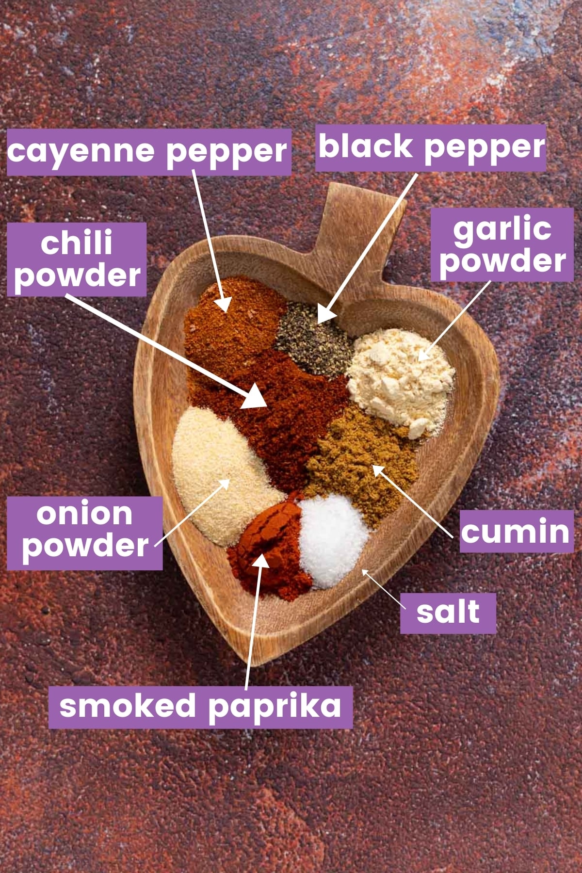 spices on a wooden heart shaped plate