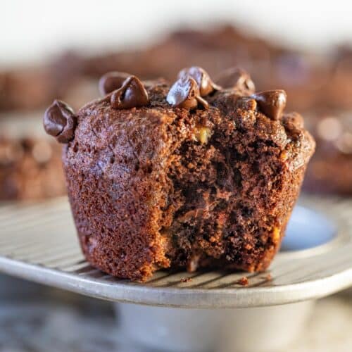 a vegan chocolate banana muffin with a bite taken out