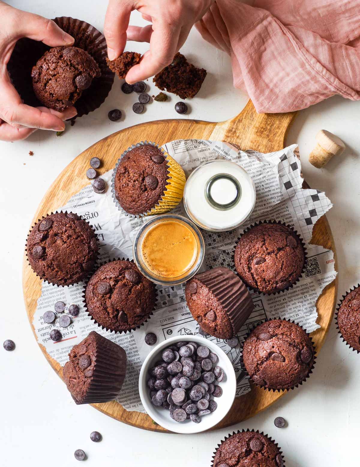 muffins on a wooden board with hands breaking one open