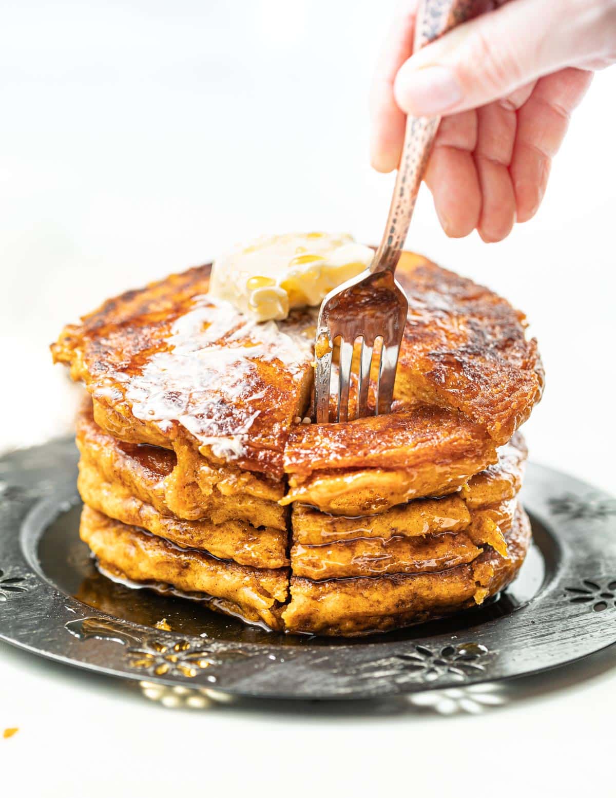 a stack of vegan pumpkin pancakes with melty butter
