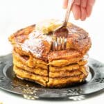 a fork going into a stack of vegan pumpkin pancakes