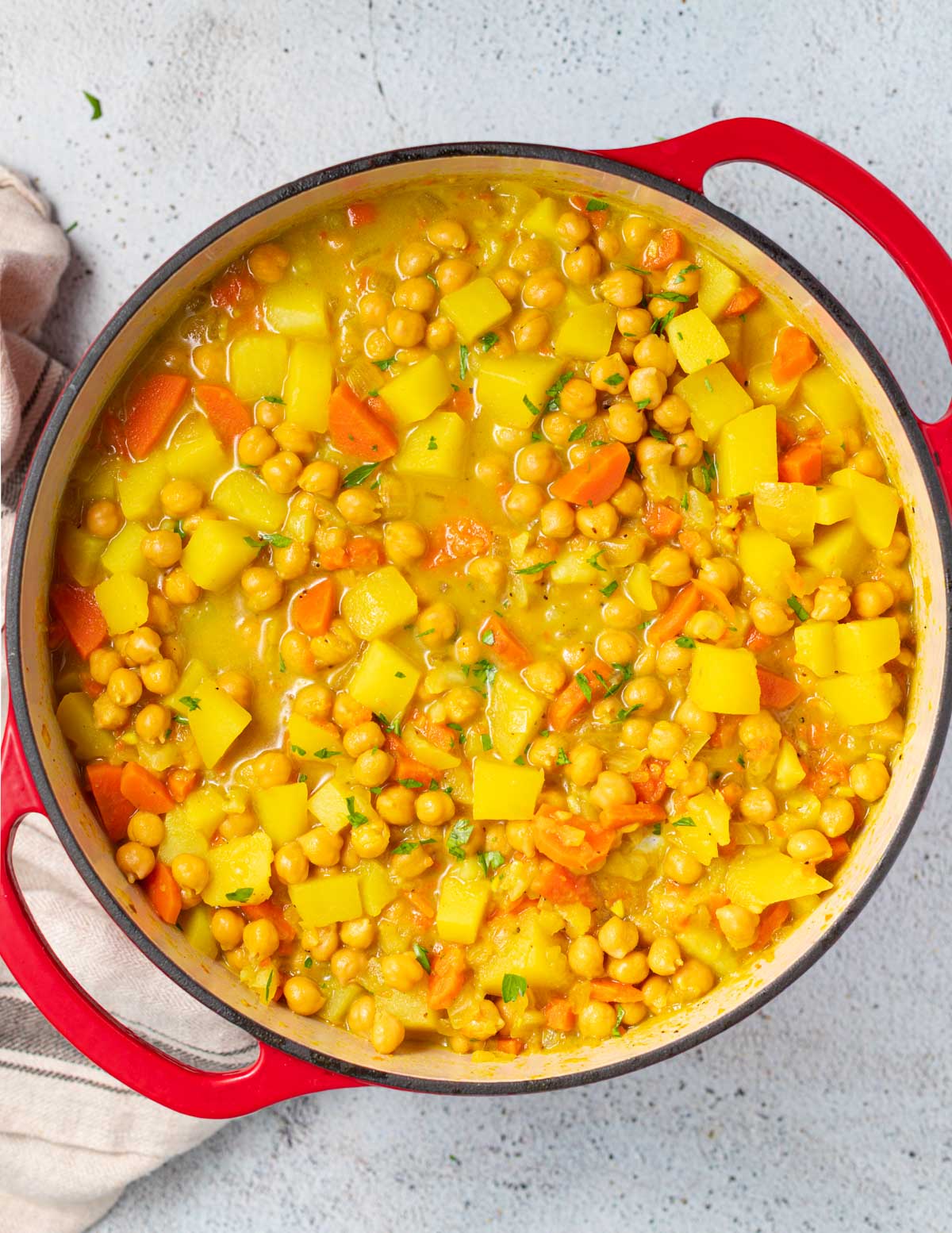 a red Dutch Oven full of chickpea curry soup 