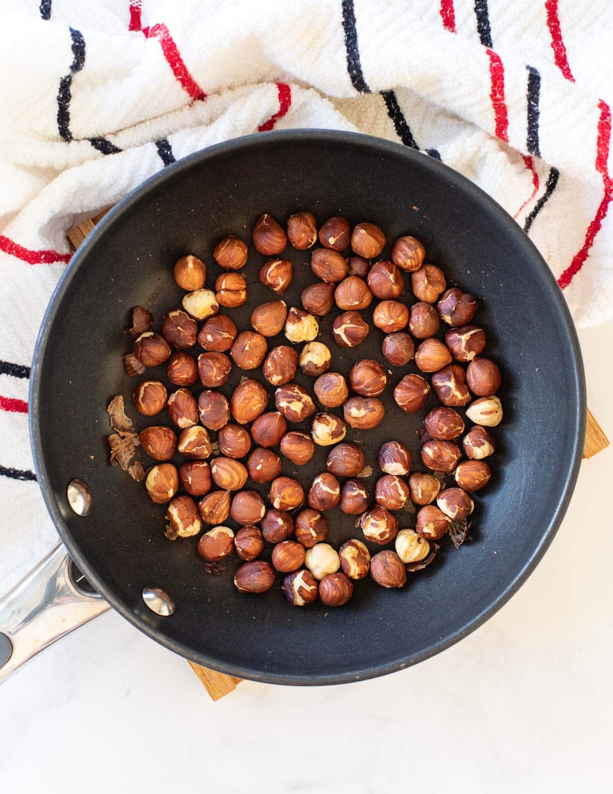 hazelnuts toasting in a pan