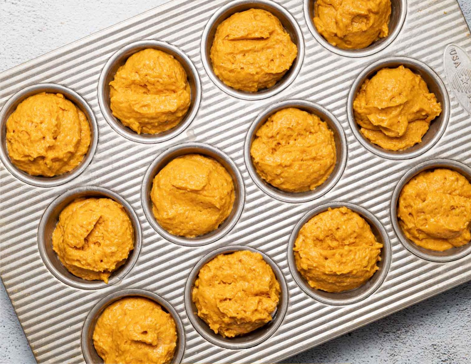 uncooked muffins in a pan