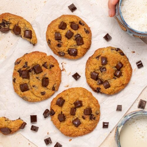 4 chocolate chip cookies on a square of parchment paper