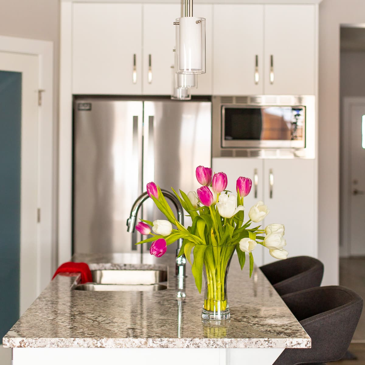 a kitchen with tulips in a vase