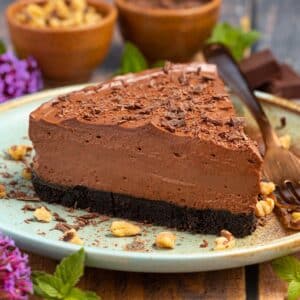 a slice of vegan chocolate cheesecake on a blue plate