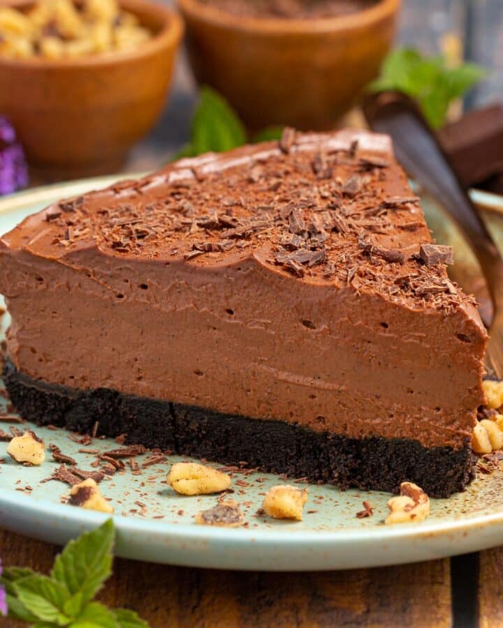 a slice of vegan chocolate cheesecake on a blue plate