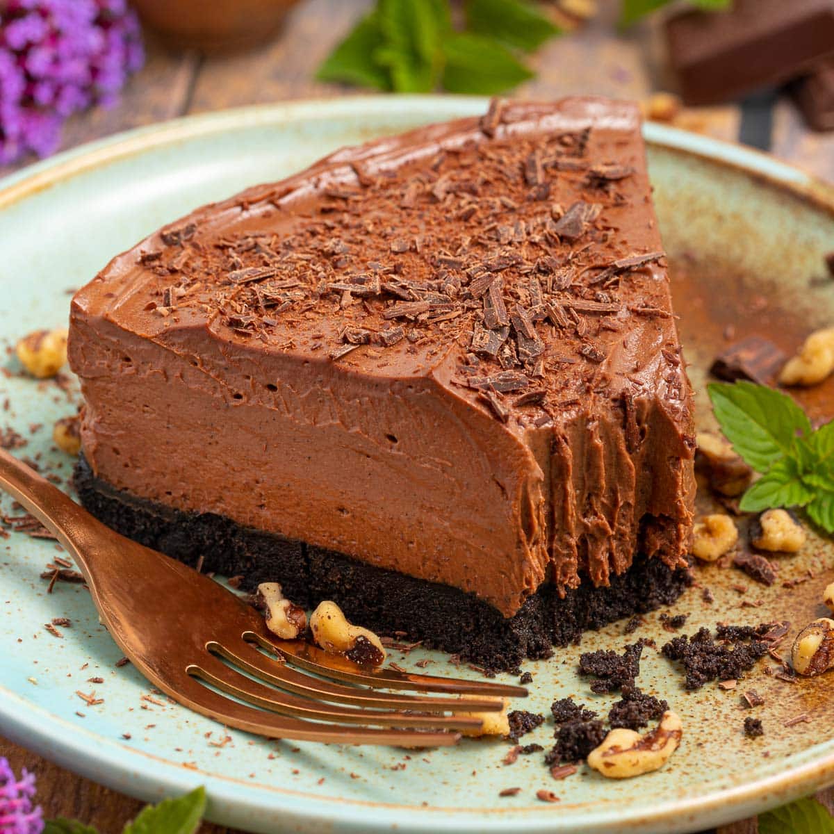 vegan chocolate cheesecake with a bite taken form the end