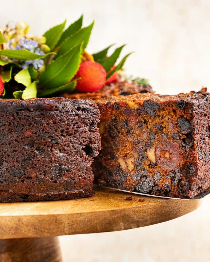 a slice of vegan christmas cake being pulled out of the cake