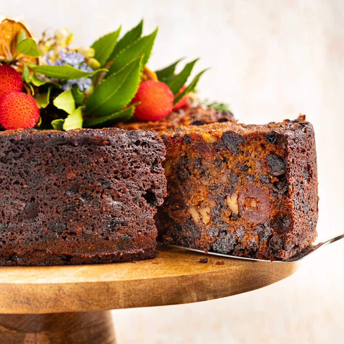 a slice of vegan christmas cake being pulled out of the cake