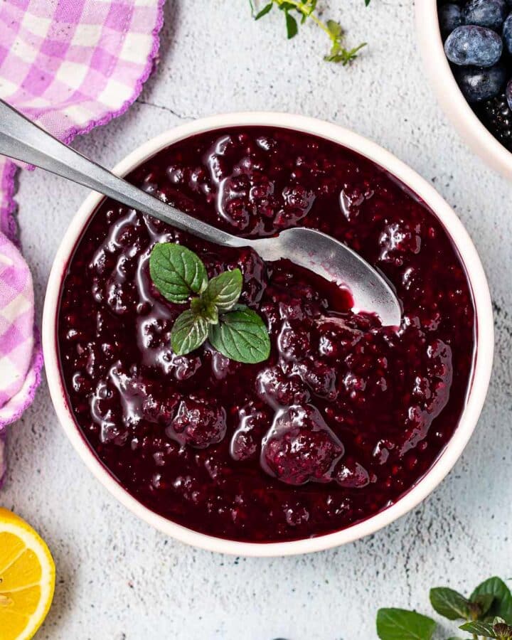 a bowl of compote with a spoon