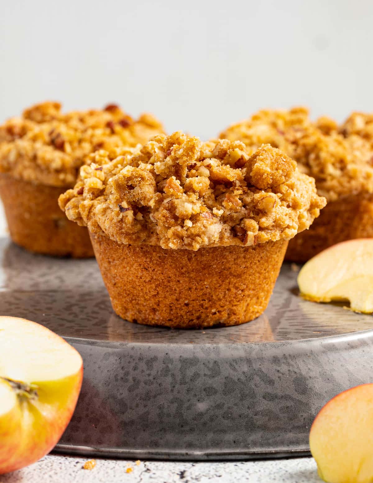 3 vegan apple muffins with some apple pieces