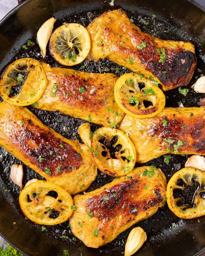 vegan chicken breasts in a pan with lemon slices