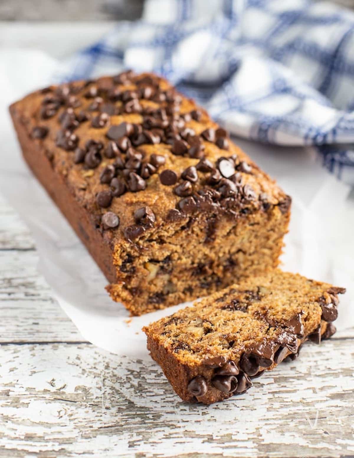 a loaf of banana bread with one slice cut off. 