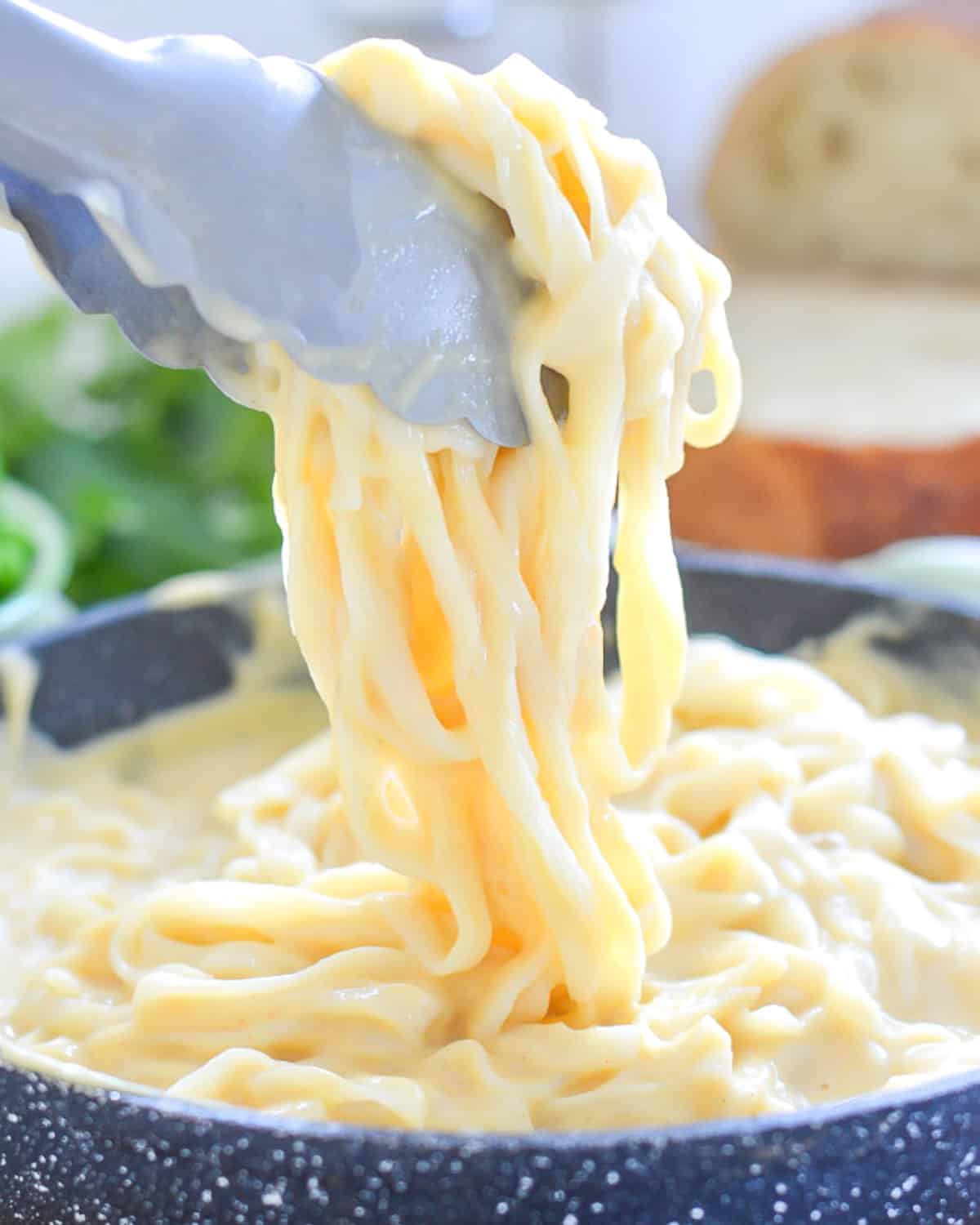 tongs picking up some cauliflower alfredo