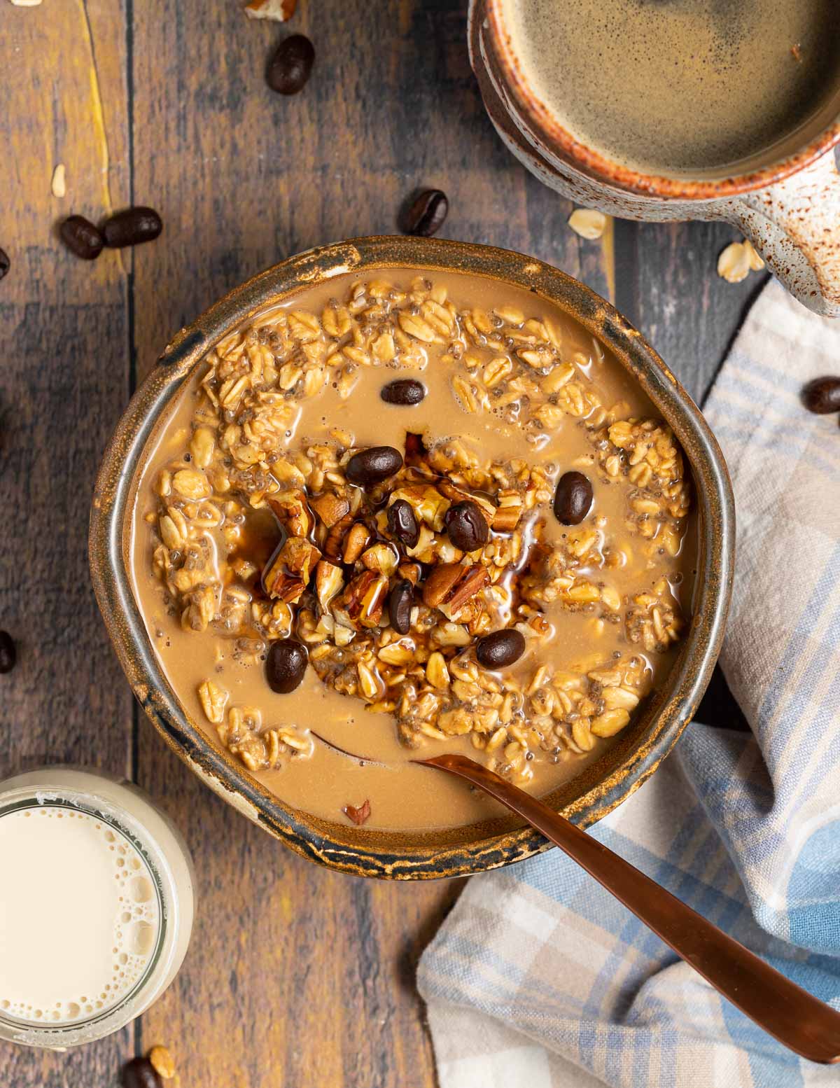 a bowl of coffee overnight oats on a wooden surface