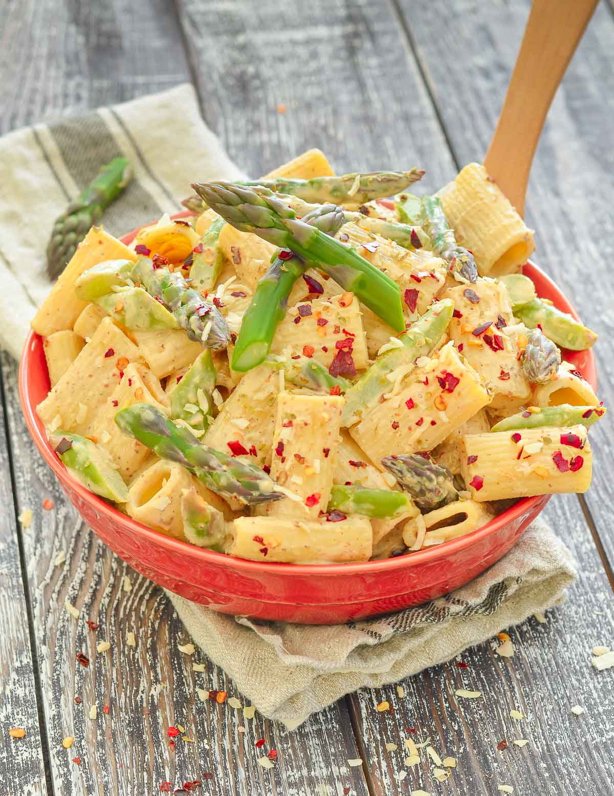 a bowl of vegan asparagus pasta with chili flake garnish 