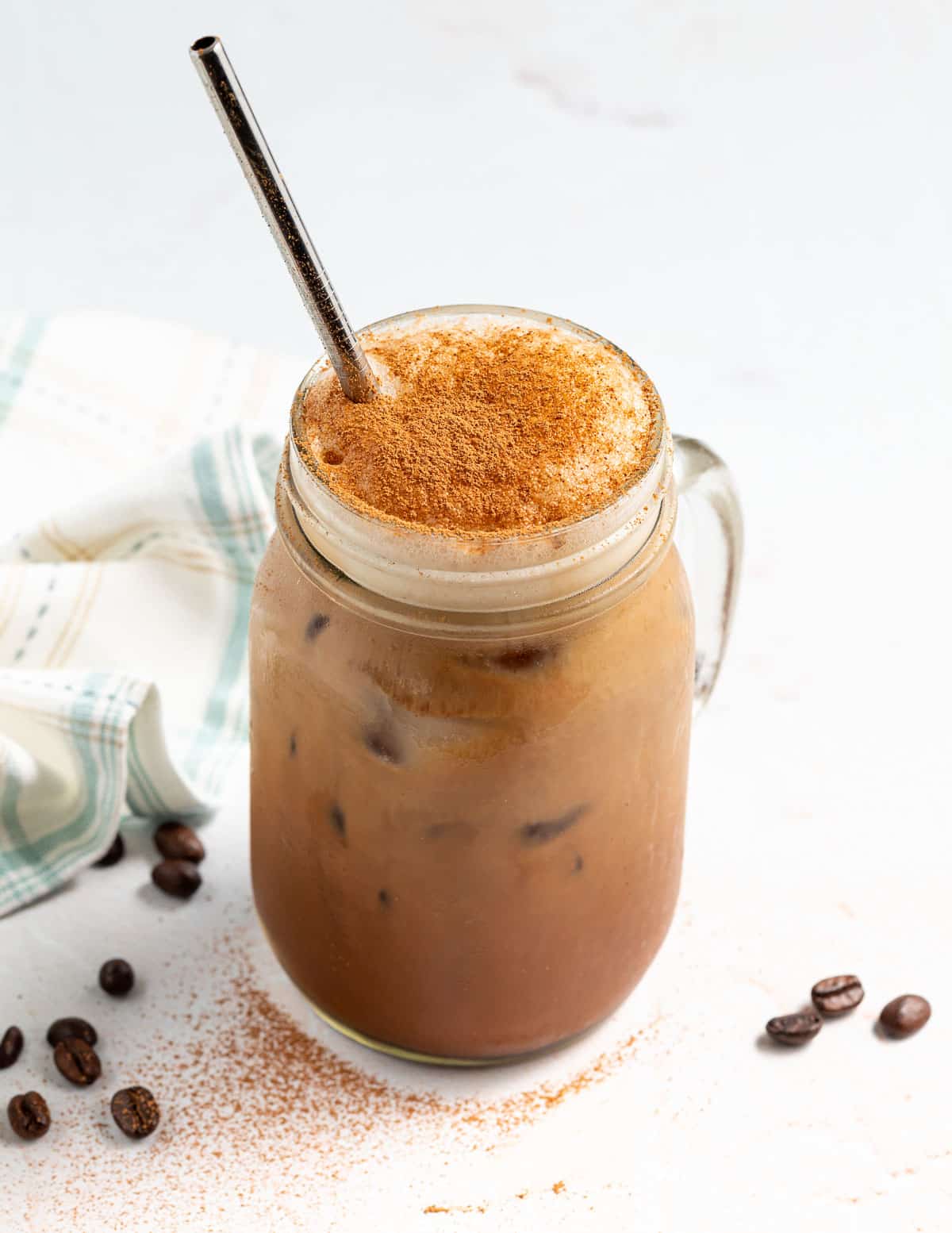 an Iced Chocolate Almondmilk Shaken Espresso in a glass with a stainless steel str