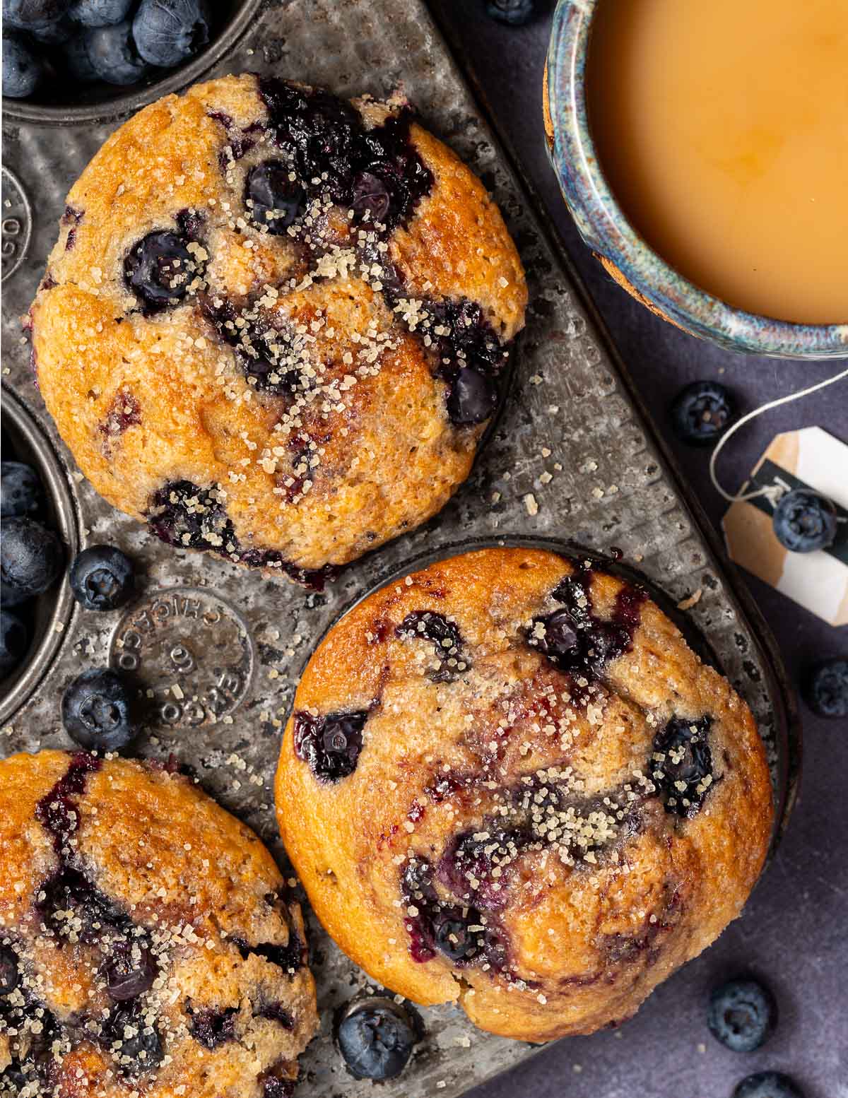 vegan blueberry muffins in a vintage muffin pan