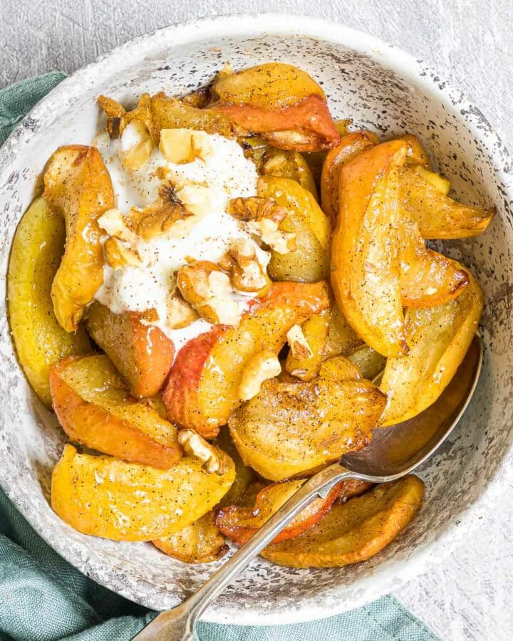 a bowl of air fryer apples with yogurt and walnuts