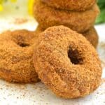 a vegan pumpkin donut leaning on another donut