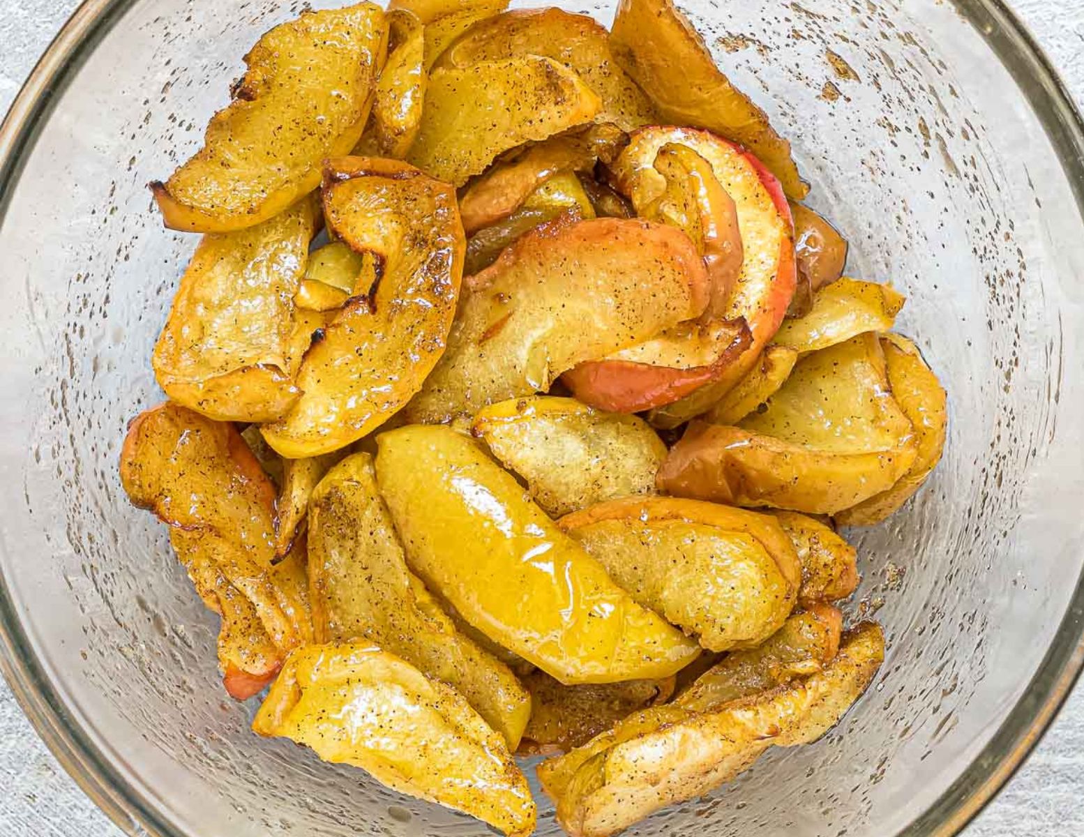 cooked apple slices tossed in melted butter and spices