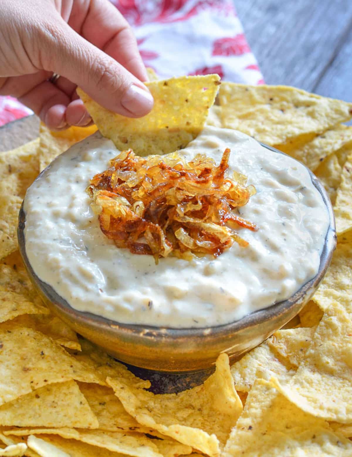 a bowl of dip surrounded by tortilla chips