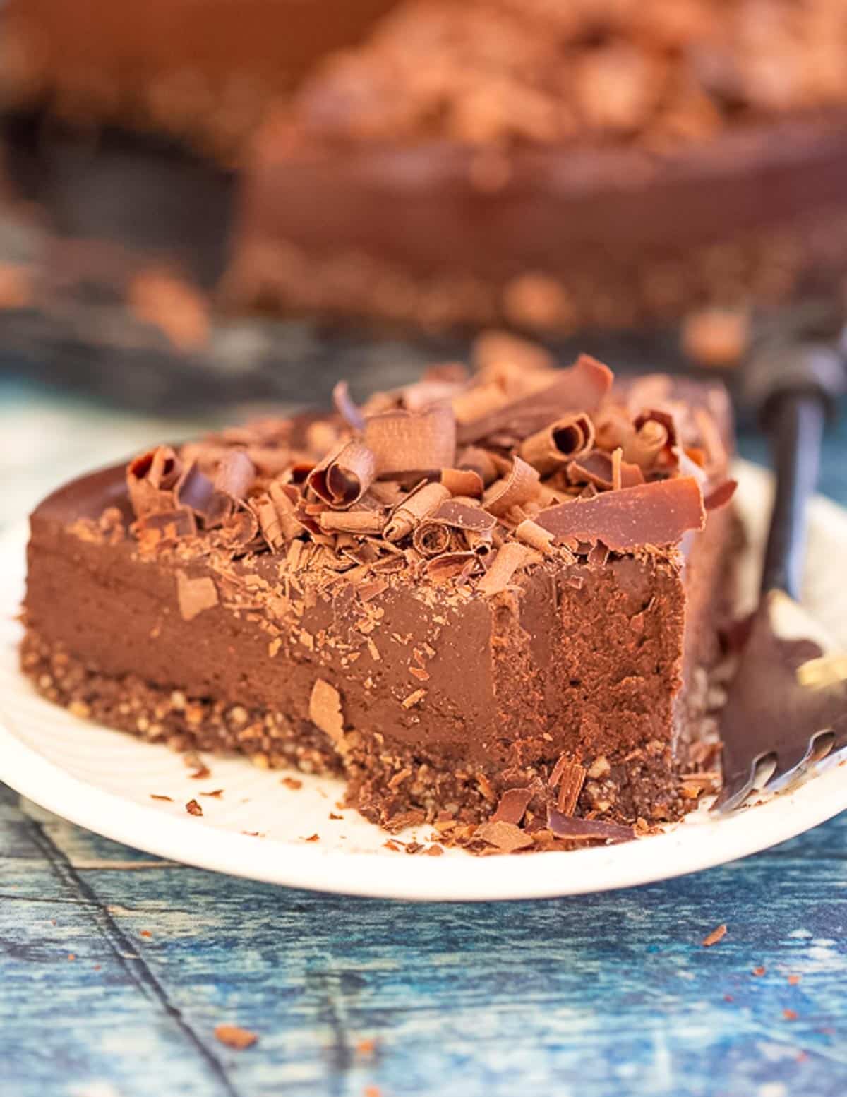 a slice of no bake chocolate cake with a bite taken from the end