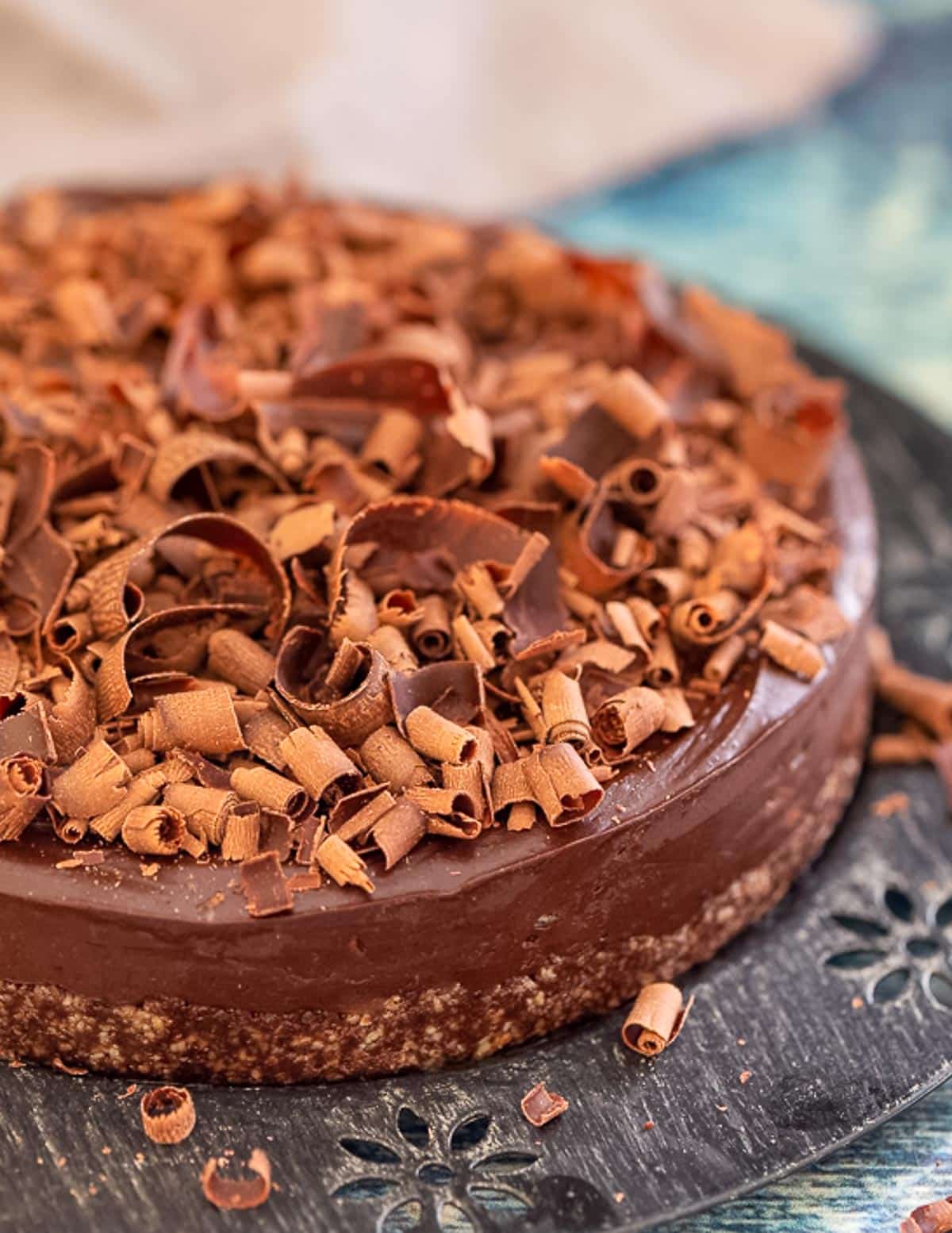 close up photo of a no bake chocolate cake covered in chocolate curls