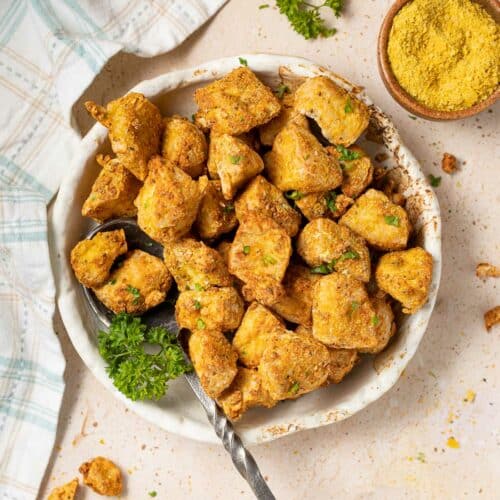 a bowl of nutritional yeast tofu garnished with parsley