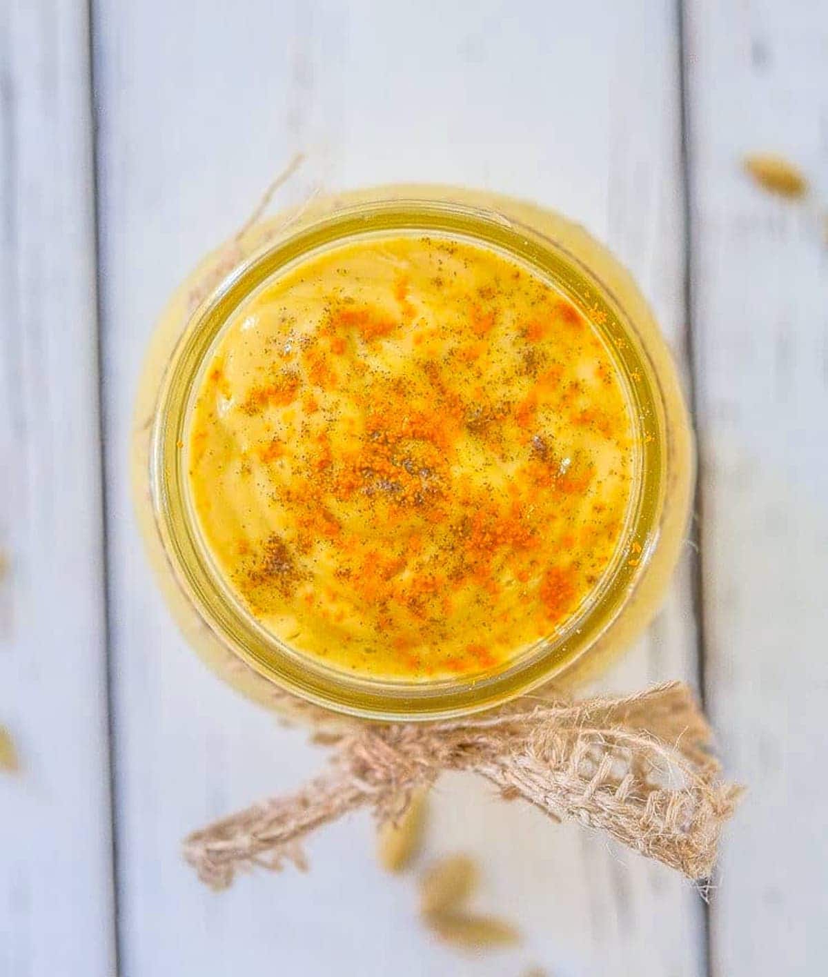 mango banana smoothie in a glass, photo taken top down