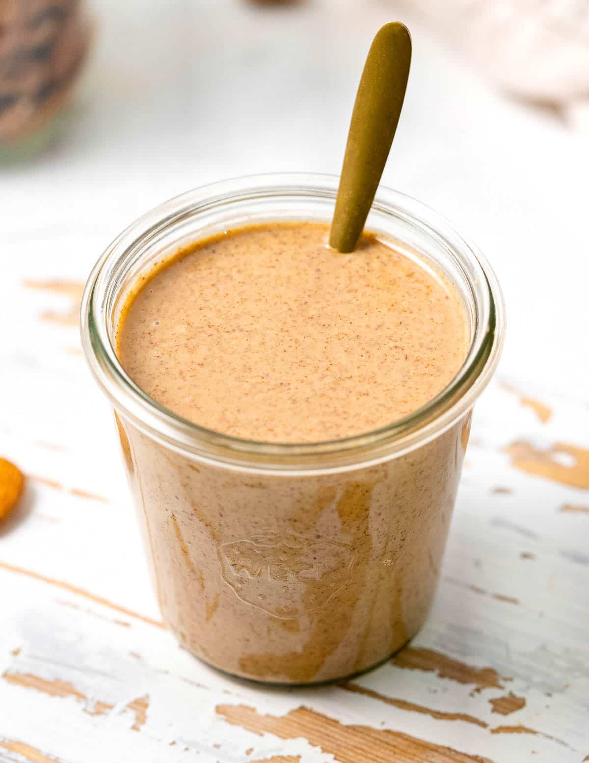 runny almond butter in an open jar