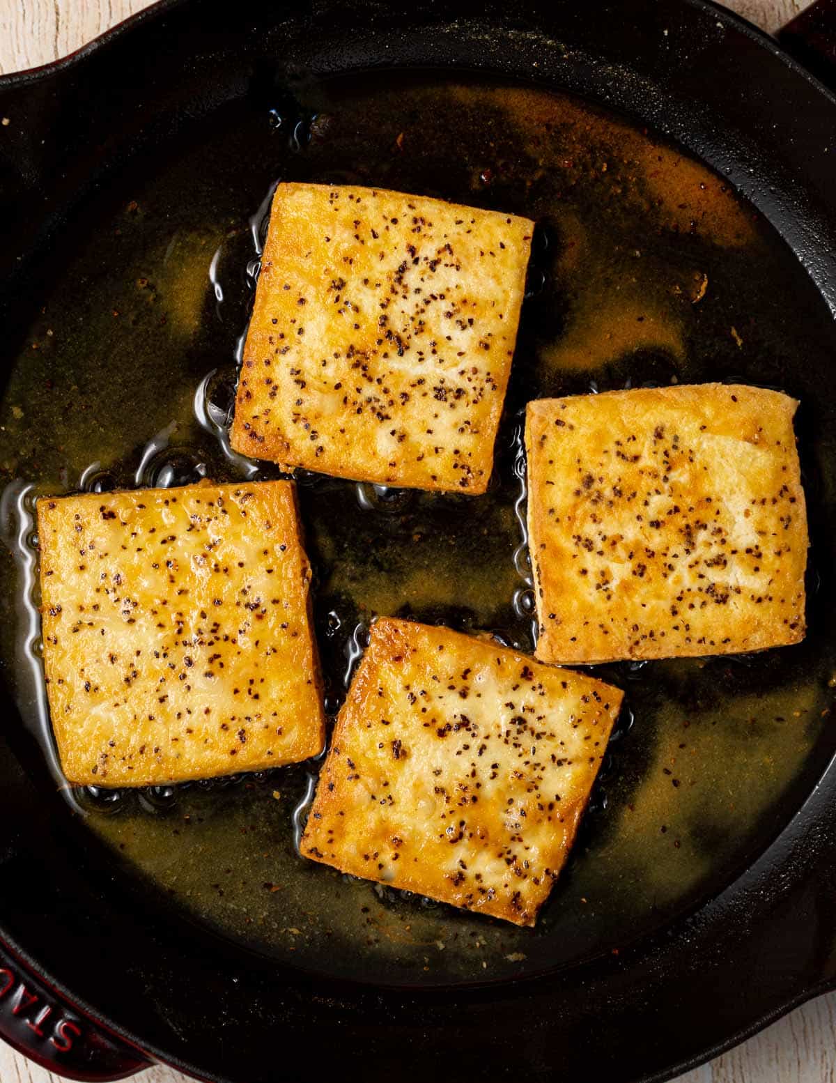 fried tofu squares in a pan