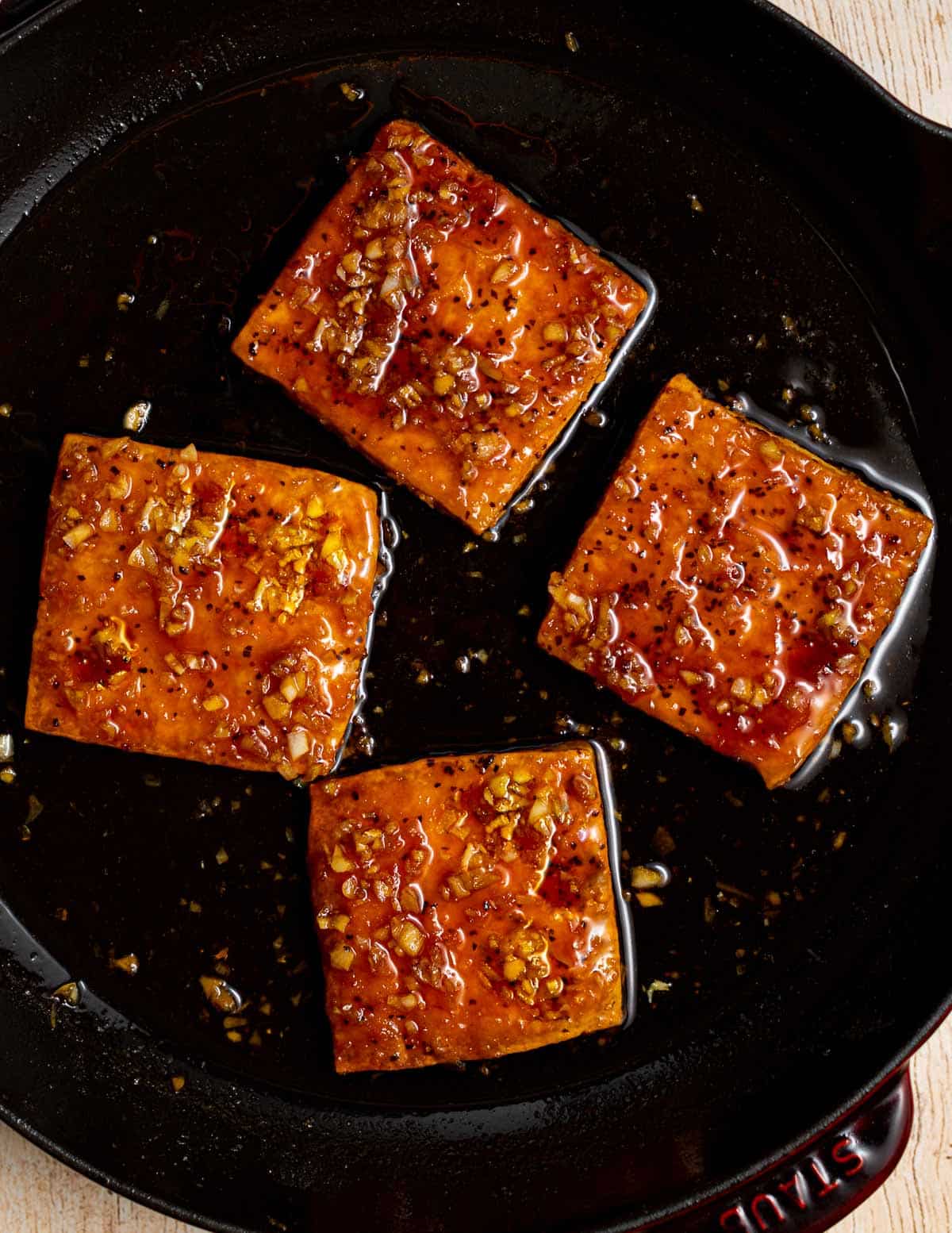 sticky caramelized tofu squares in a pan