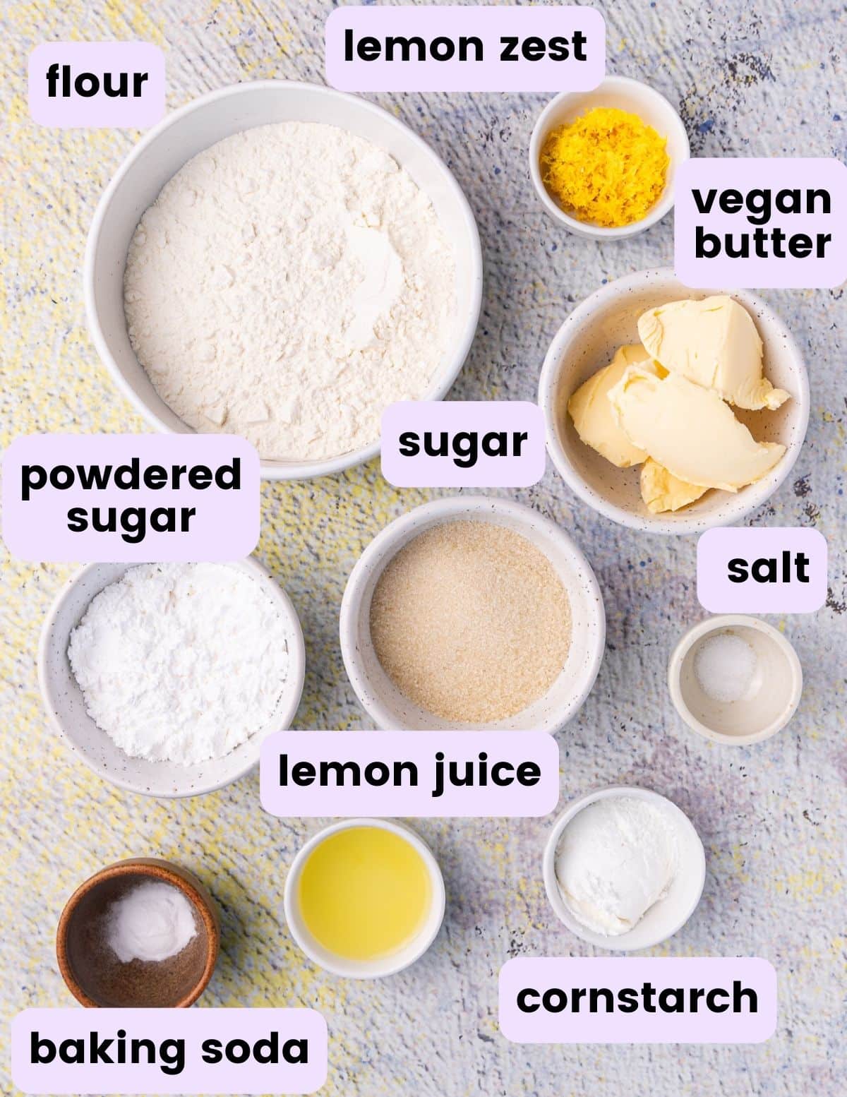 flour, lemon zest, vegan butter, sugar, powdered sugar, salt, baking soda, lemon juice, cornstarch