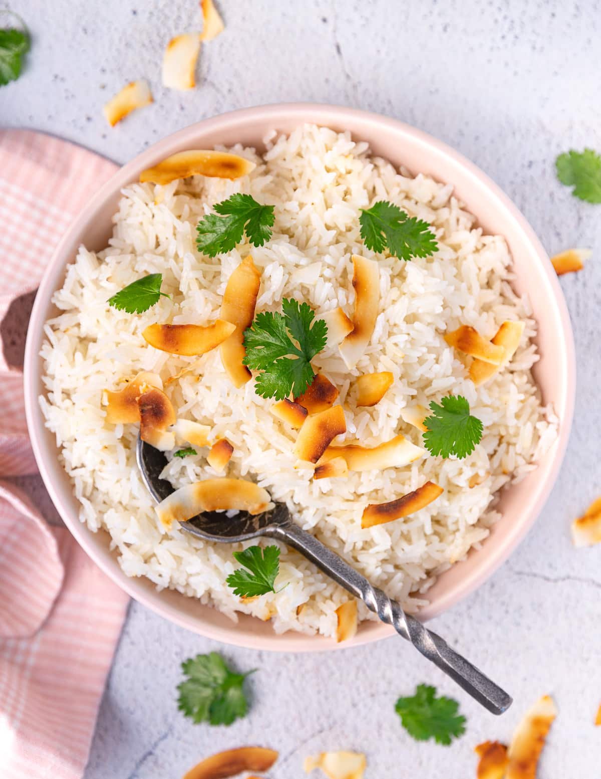 a bowl of coconut basmati rice with cilantro and coconut