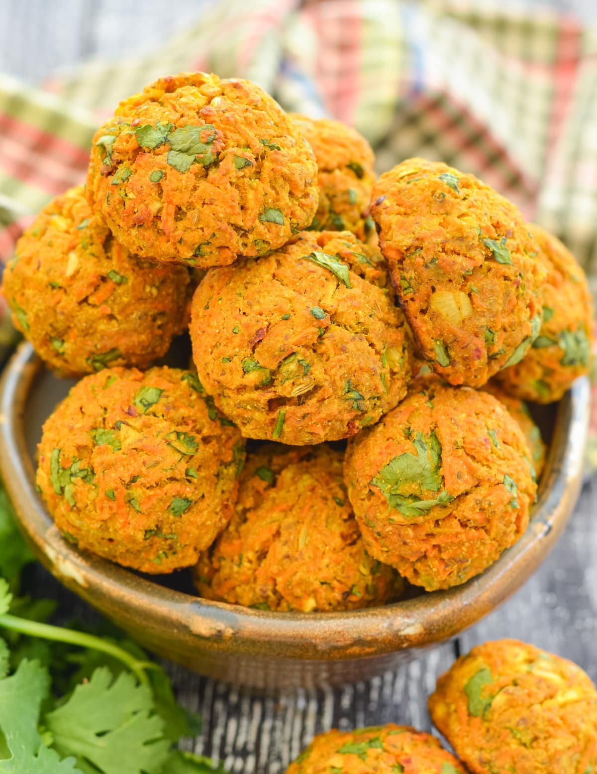 a bowl piled high with curried carrot falafel