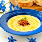 a bowl of vegan cauliflower soup topped with caramelized onions and thyme