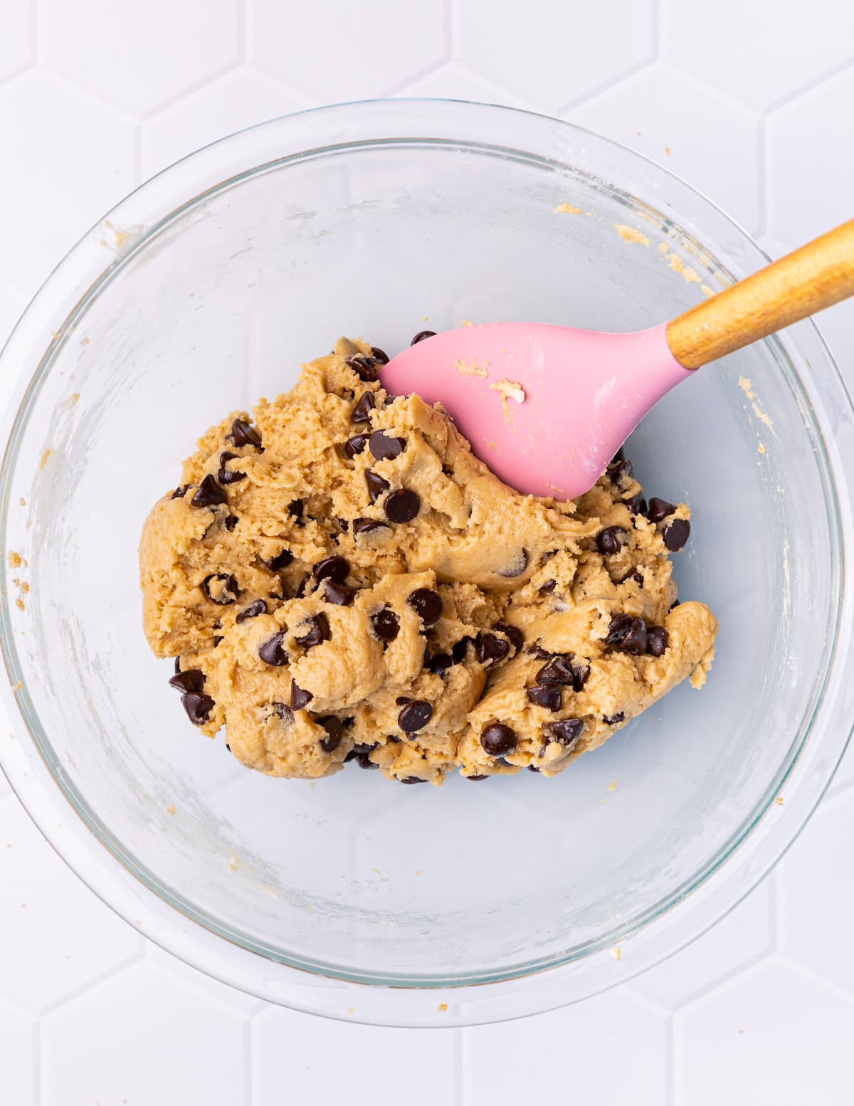 cookie dough in a bowl with a pink spatula