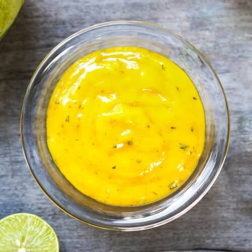 a bowl of mango salad dressing