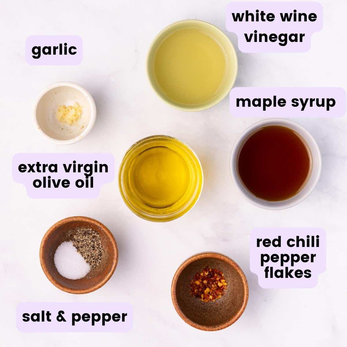the vinaigrette ingredients: white wine vinegar, garlic, extra virgin olive oil, maple syrup, salt & pepper, red chili pepper flakes