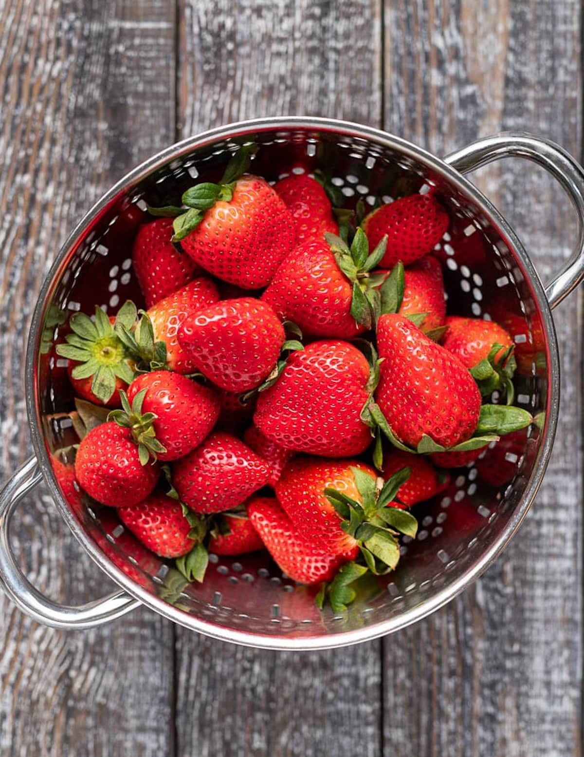 a colander of strawberries