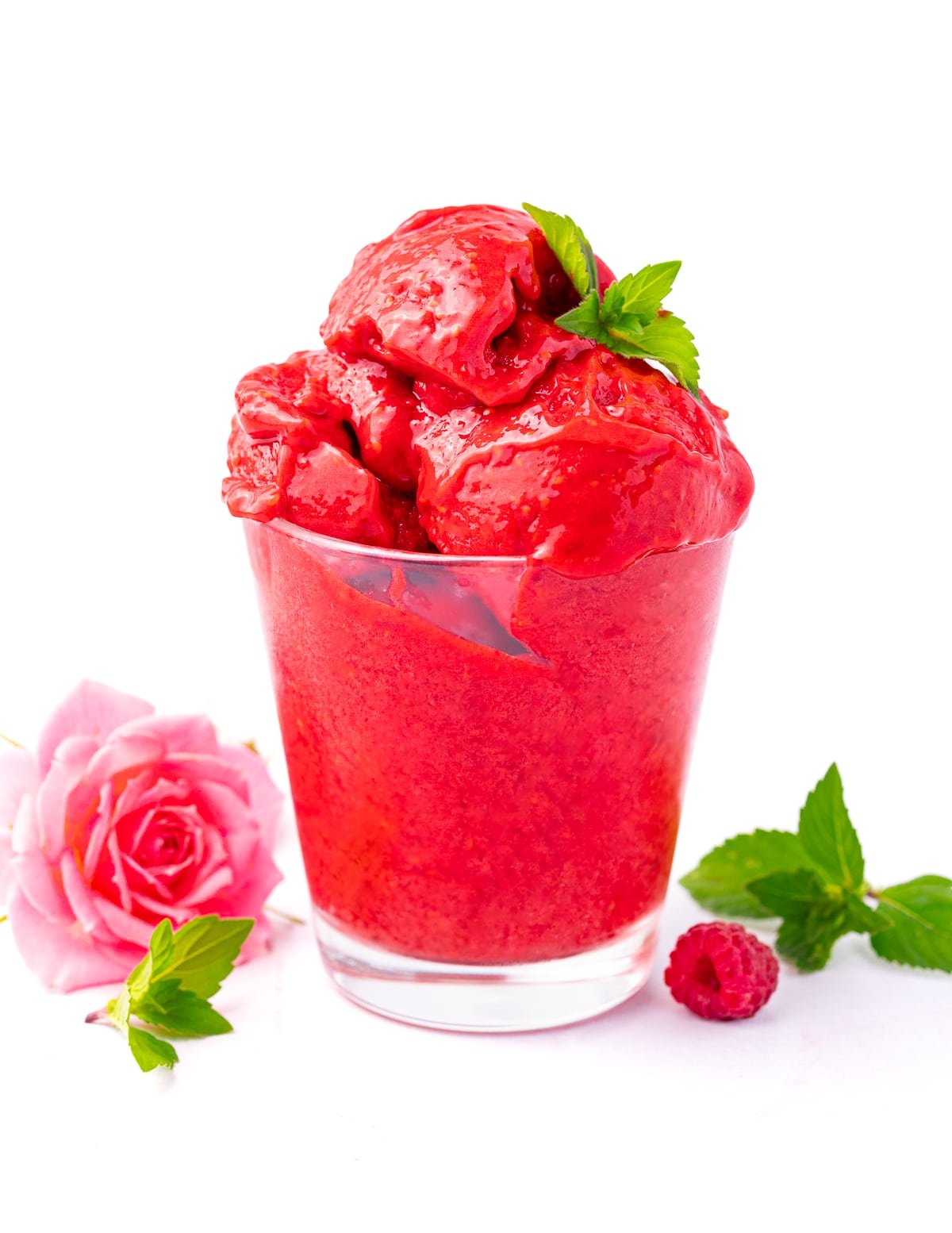 a glass of raspberry sorbet garnished with mint