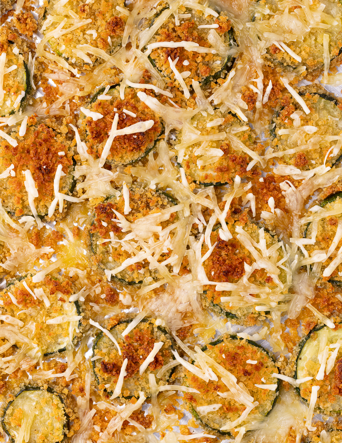 a tray of crispy, cheesy, zucchini slices