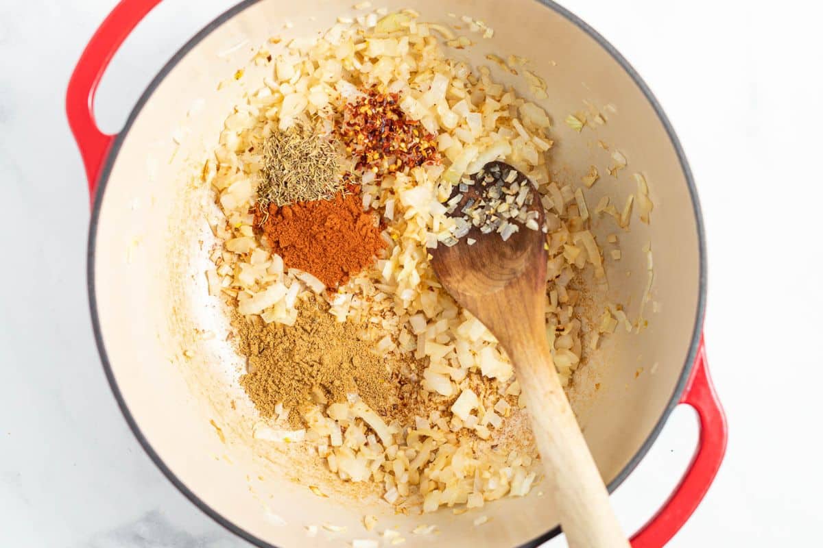 onions, garlic and spices sautéing in a Dutch oven. 