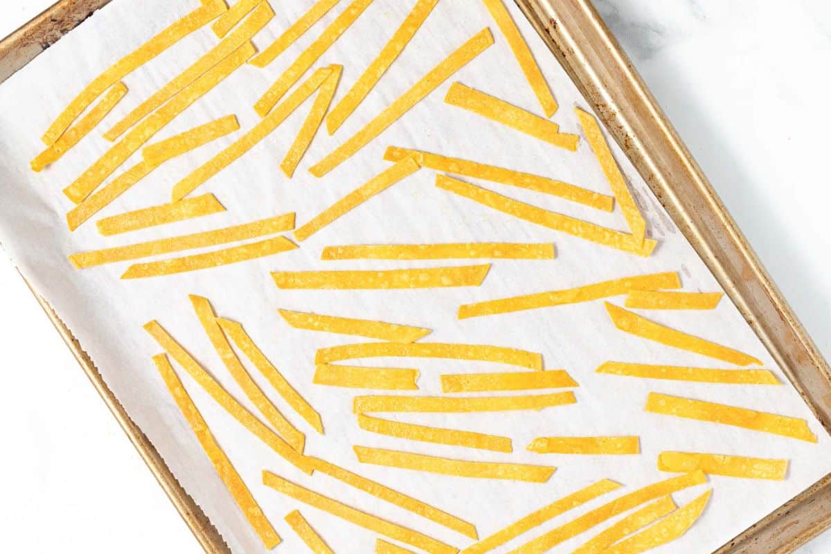 crispy tortilla strips on a baking tray