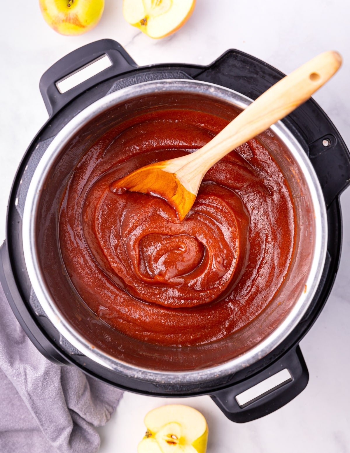 apple butter in an Instant Pot with a wooden spoon