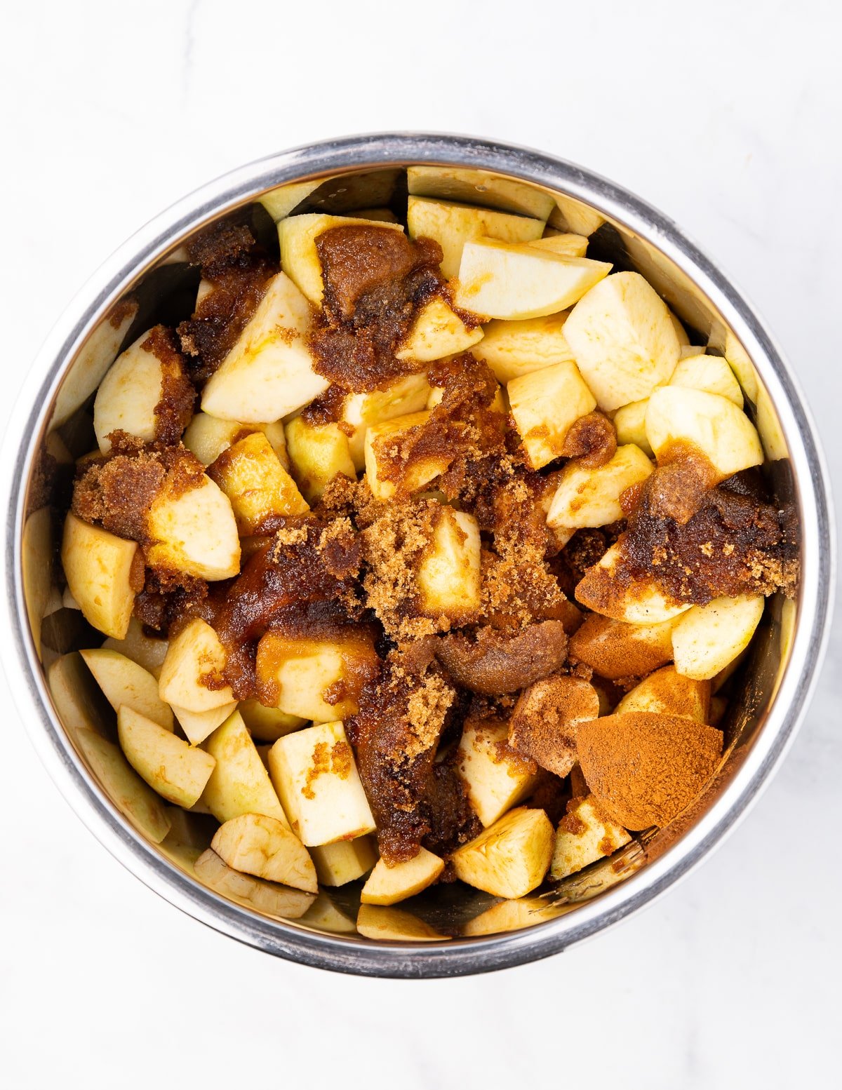 uncooked apples, sugar, and spices in an Instant Pot