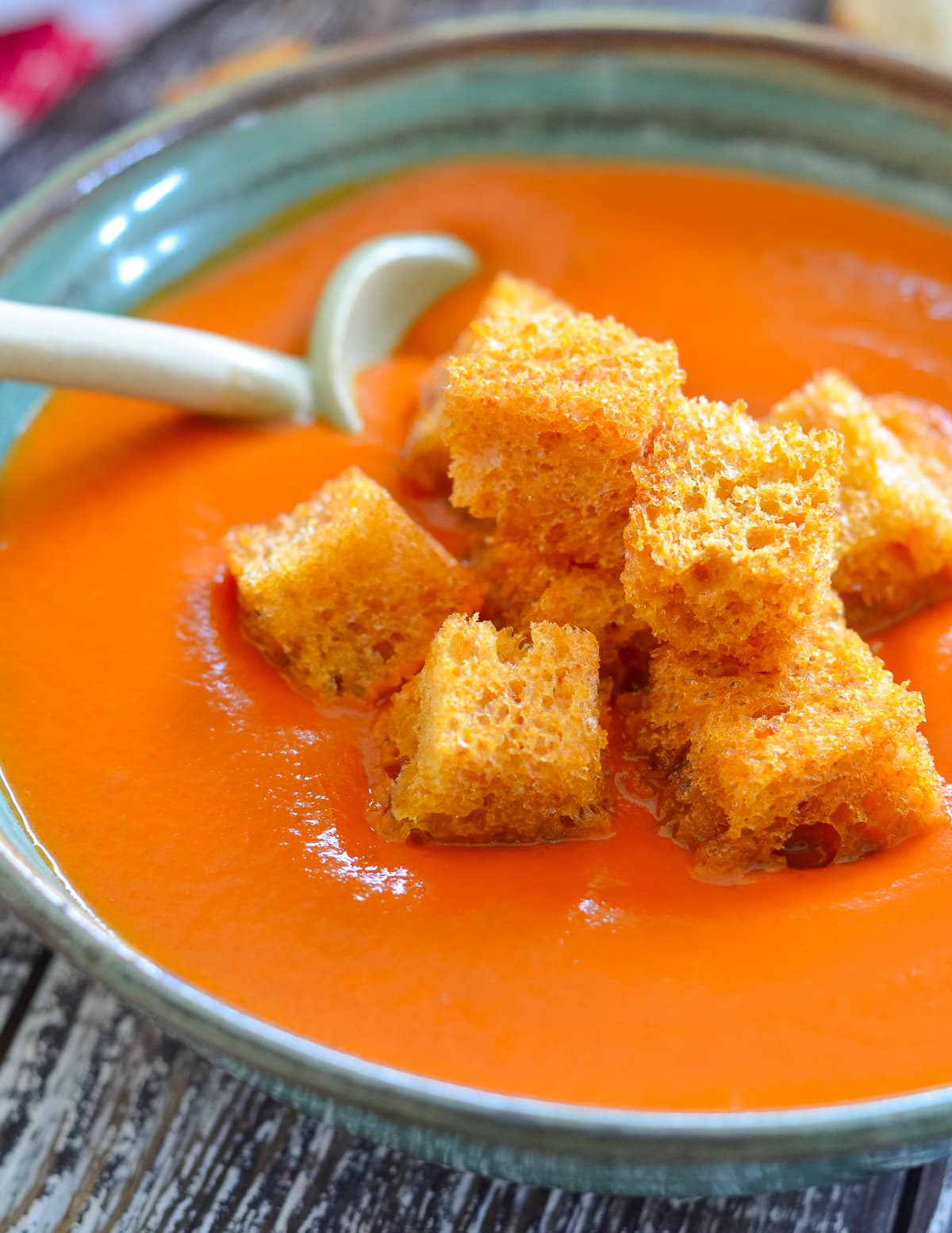 a bowl of vegan tomato soup with croutons